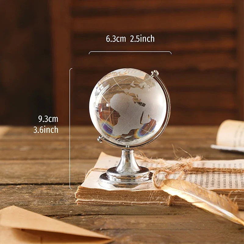 Transparent globe with a silver-coloured stand and a diagram showing 9.3 cm height and 6.3 cm globe width