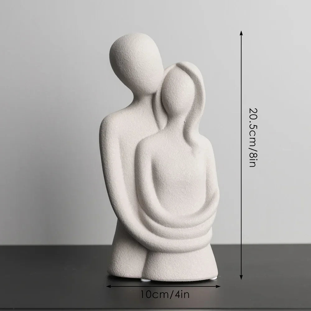 Beige abstract embracing couple sculpture with a diagram showing 20.5 cm height and 10 cm width