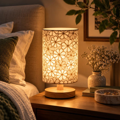 Beige floral table lamp with wooden base and soft warm light