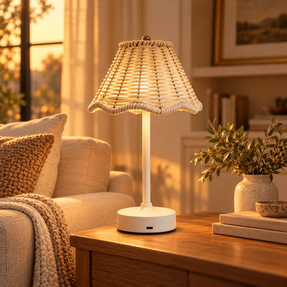 Cordless rattan table lamp glowing on a side table in a warm living room