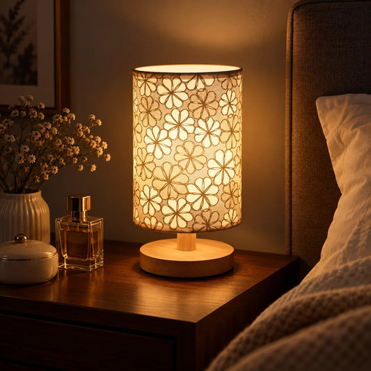 Floral fabric shade table lamp with natural wood base styled as warm bedroom lighting