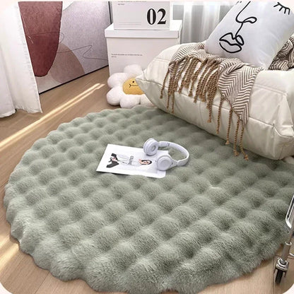 Round green plush rug with a raised grid pattern in front of an armchair, with headphones and a magazine