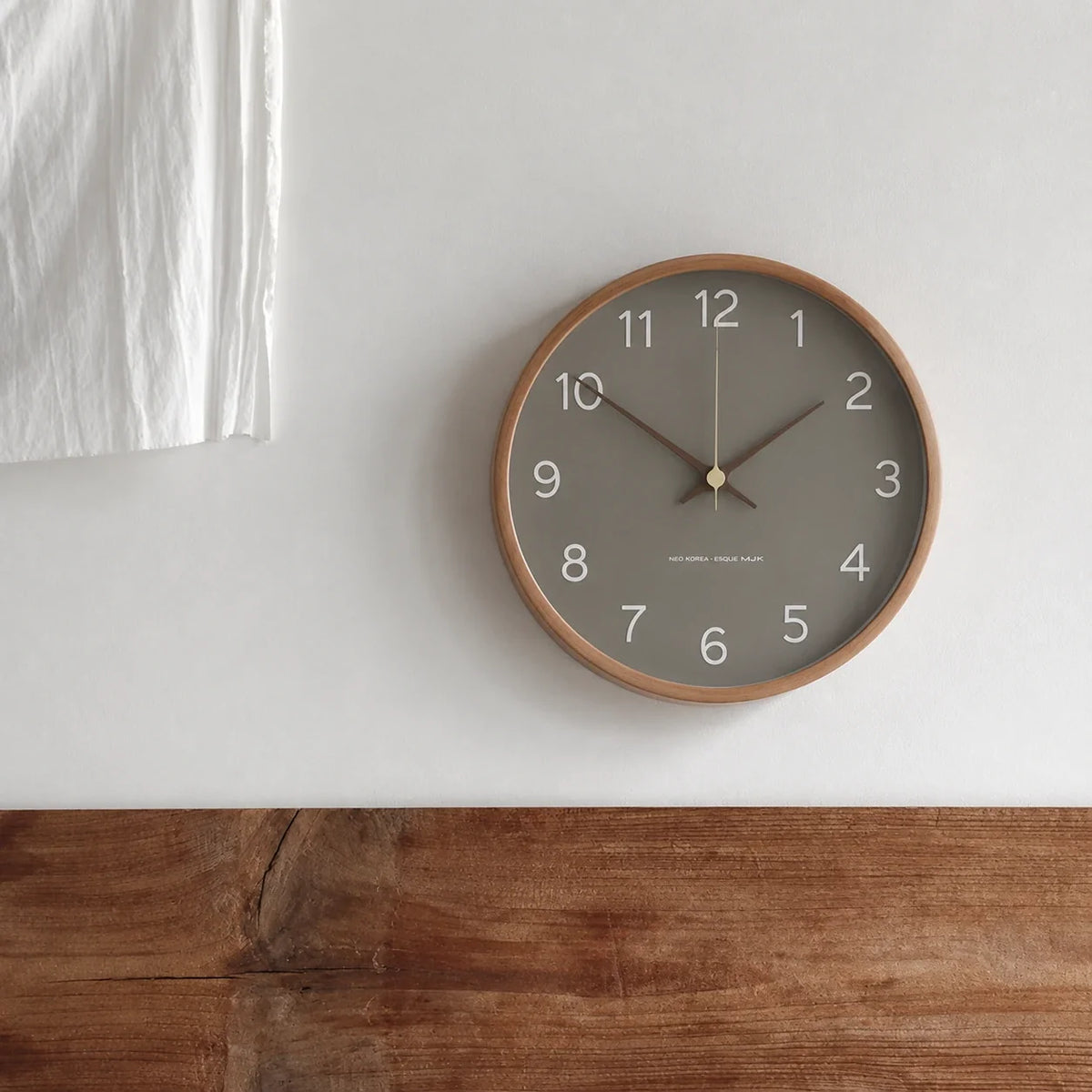 Milano Gray 25cm grey wall clock, mounted on a plain wall
