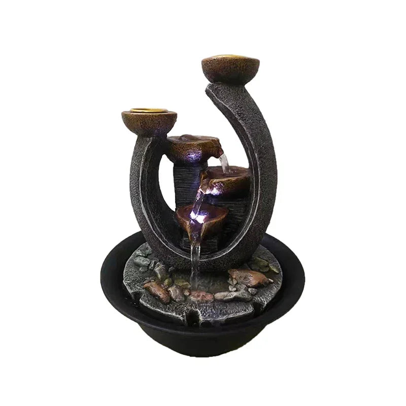 Curved indoor water fountain with purple lighting beneath its bowls, shown on a white background