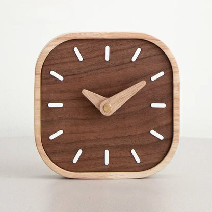 Rounded square wooden desk clock with a dark wood-grain face, pale frame and white hour markers