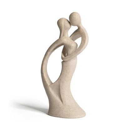 Beige abstract couple sculpture with curved interlocking bodies and featureless heads on a white background