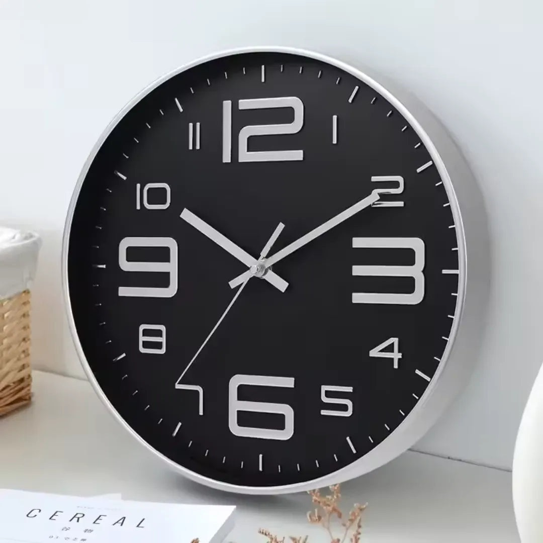 Aurelio Silver & Black 30cm silver wall clock, angled view on the wall