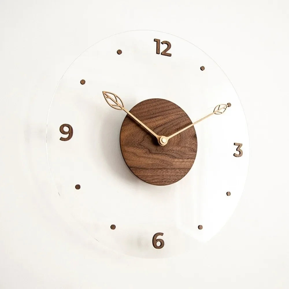 Transparent wall clock with a walnut centre, leaf-shaped hands and brown quarter-hour numerals.