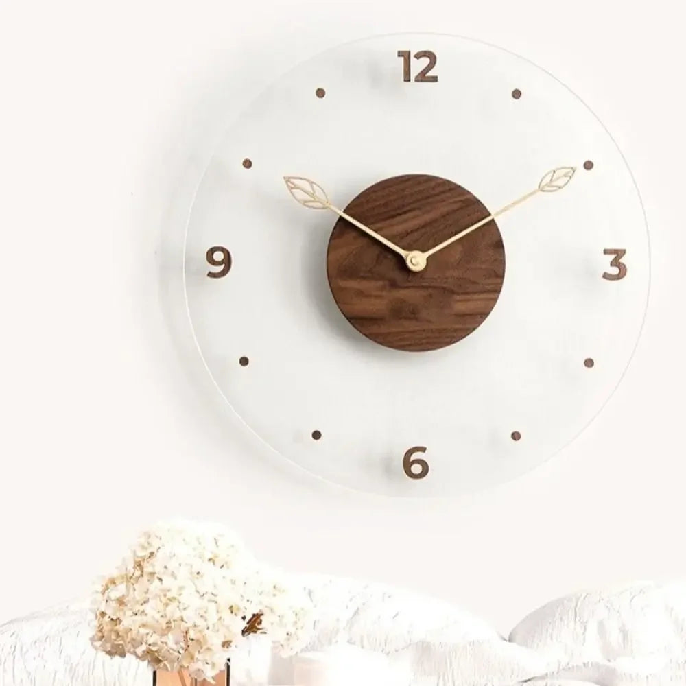 Transparent acrylic clock with a walnut centre above a pale sofa and flowers.