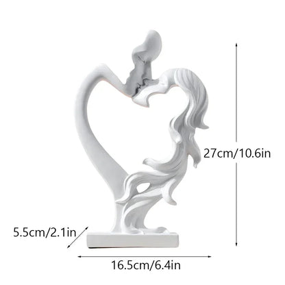 White kissing couple sculpture with a diagram showing 27 cm height, 16.5 cm width and 5.5 cm depth