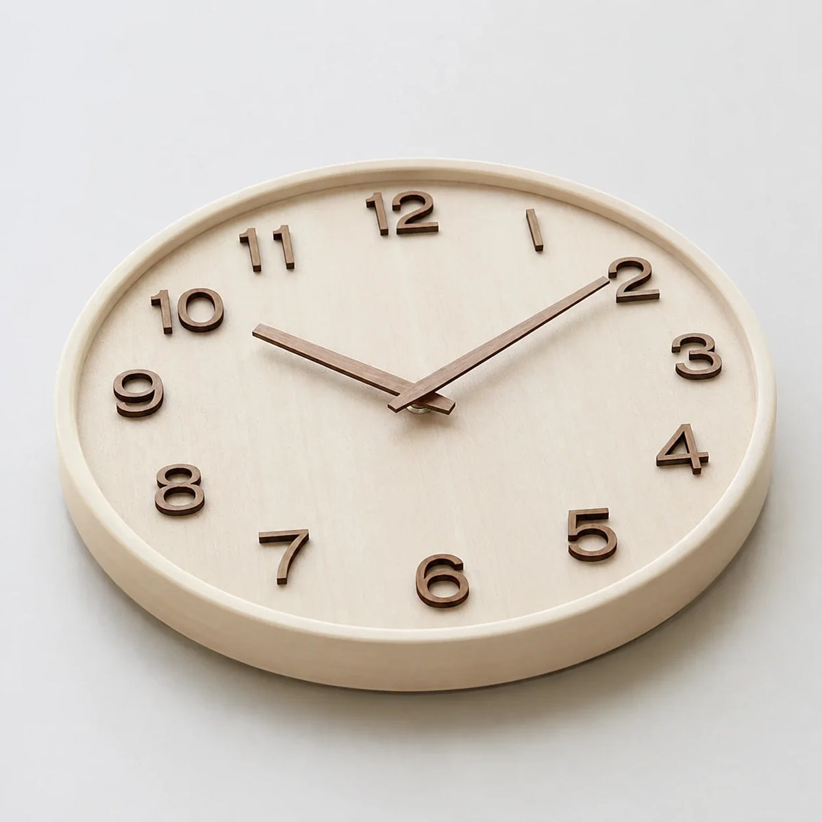 Cremona Cream Wood 30cm wooden wall clock, angled view on the wall
