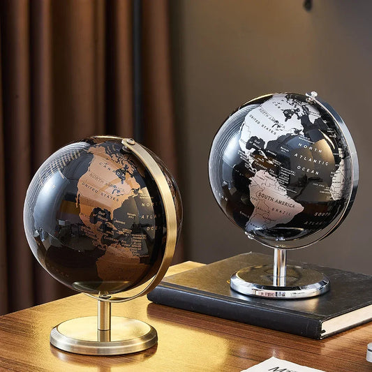 Black world map desk globes with gold-coloured and silver-coloured continents, rings and circular stands